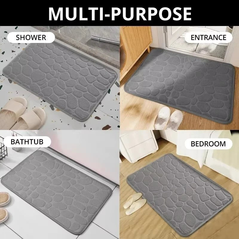 Alfombrilla de baño gris de Variedad Online con diseño de guijarros, absorbente y de secado rápido.