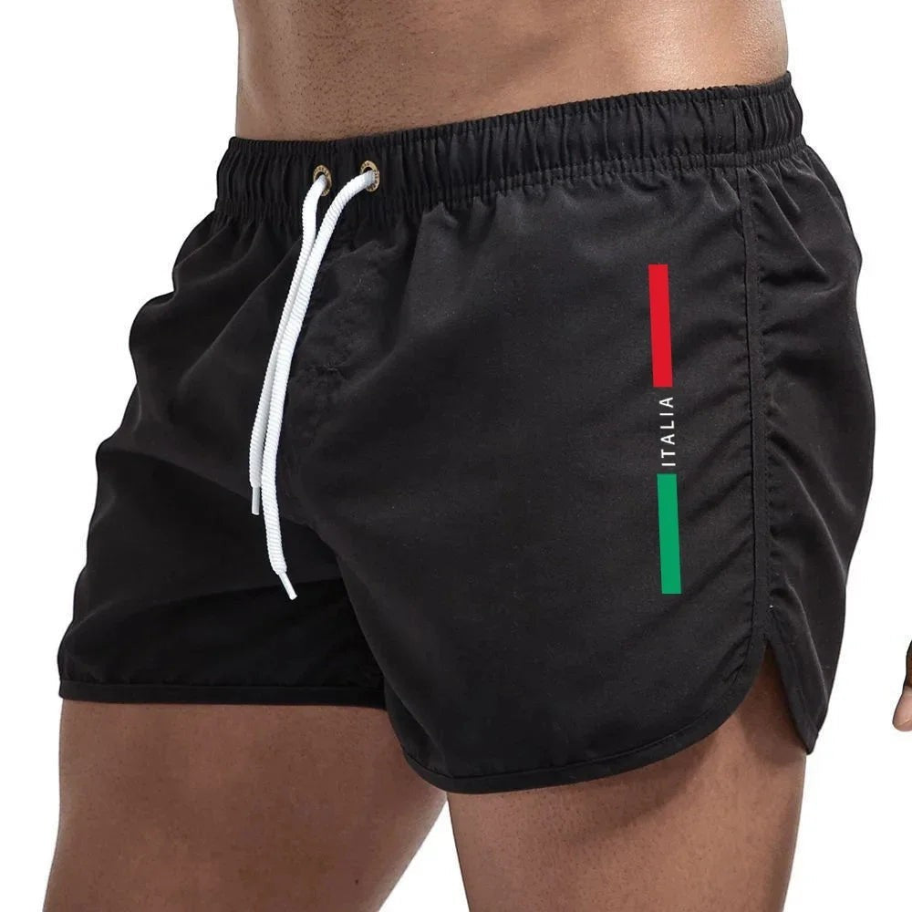 Bañadores negros de secado rápido para hombre de Variedad Online con cordón ajustable y detalle de bandera italiana.