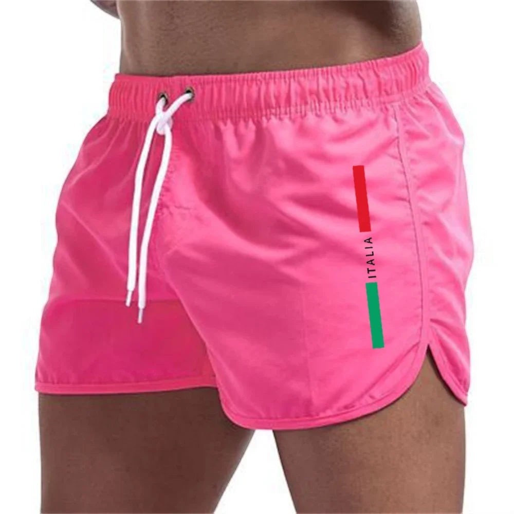 Bañadores cortos rosas de secado rápido para hombre de Variedad Online con cordón ajustable y detalle de bandera italiana.