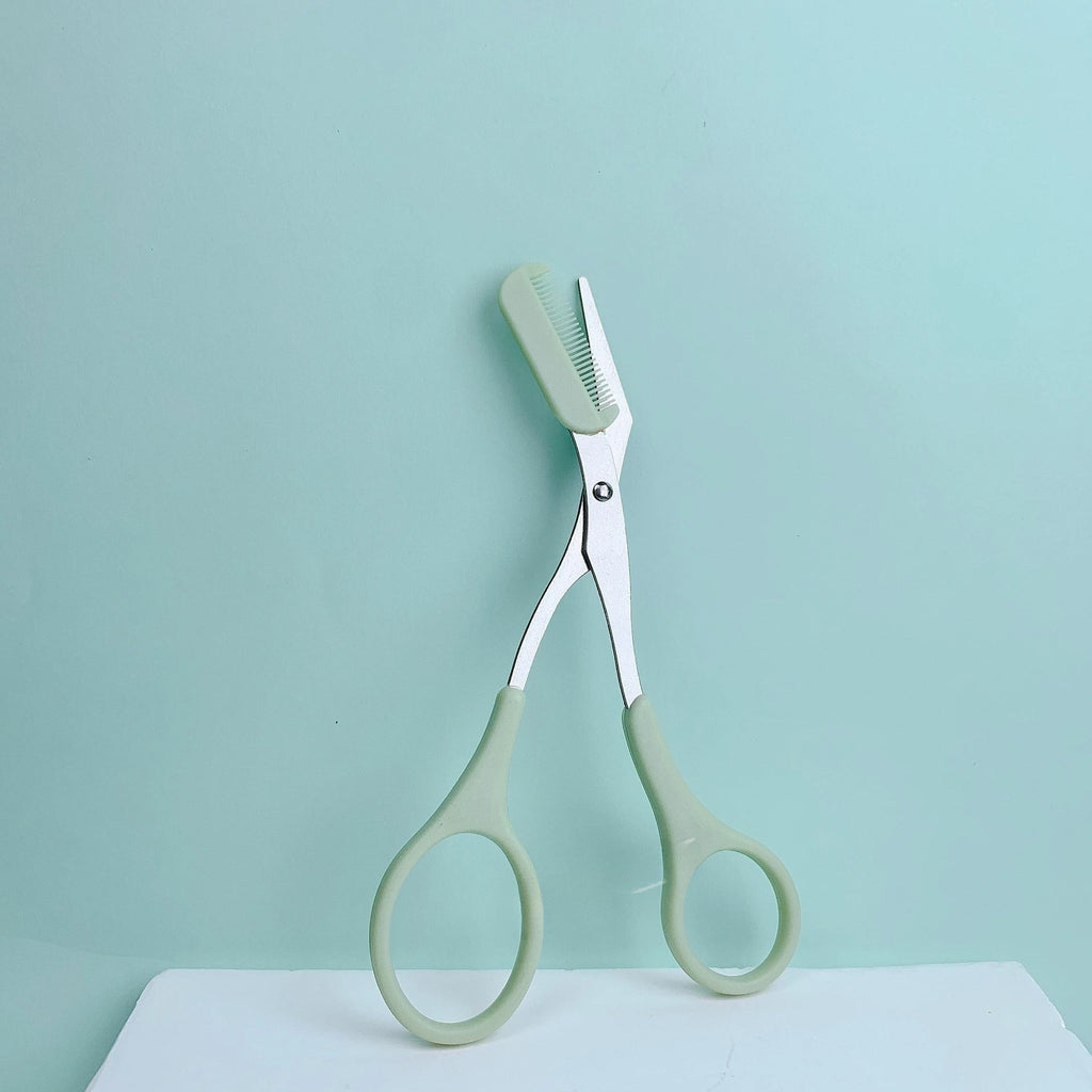 Variedad Online tijeras para cejas rosas con peine integrado para dar forma y recortar con precisión.